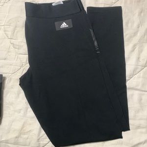 Adidas leggings.  Black with green metallic detail on back and leg.